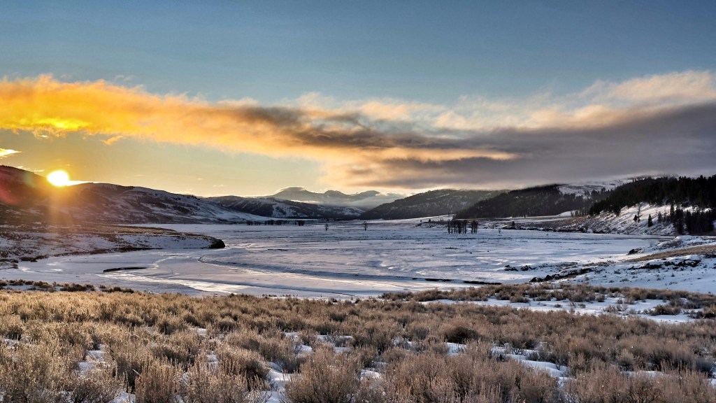 sunrise over a snowy valley
